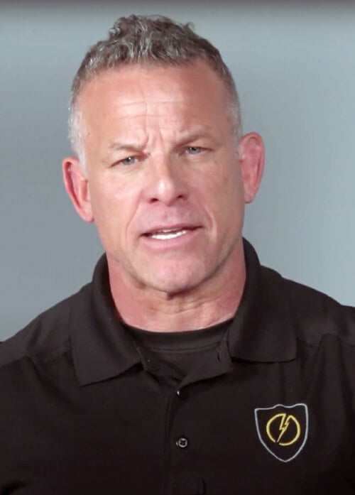 A headshot of a man in a black shirt